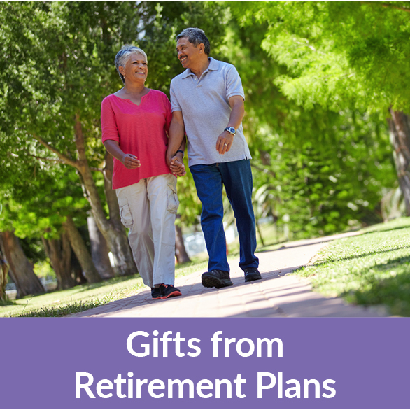 A couple walking on a trail. Gifts of Retirement Plans Rollover