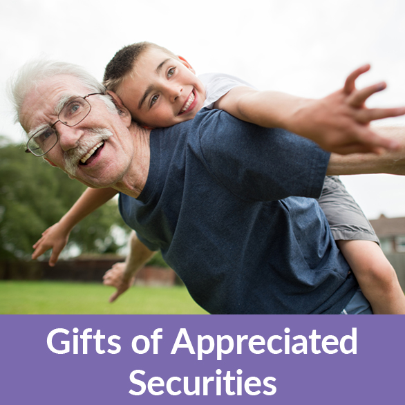 A man playing with their grandchild. Gifts of Appreciated Securities Rollover